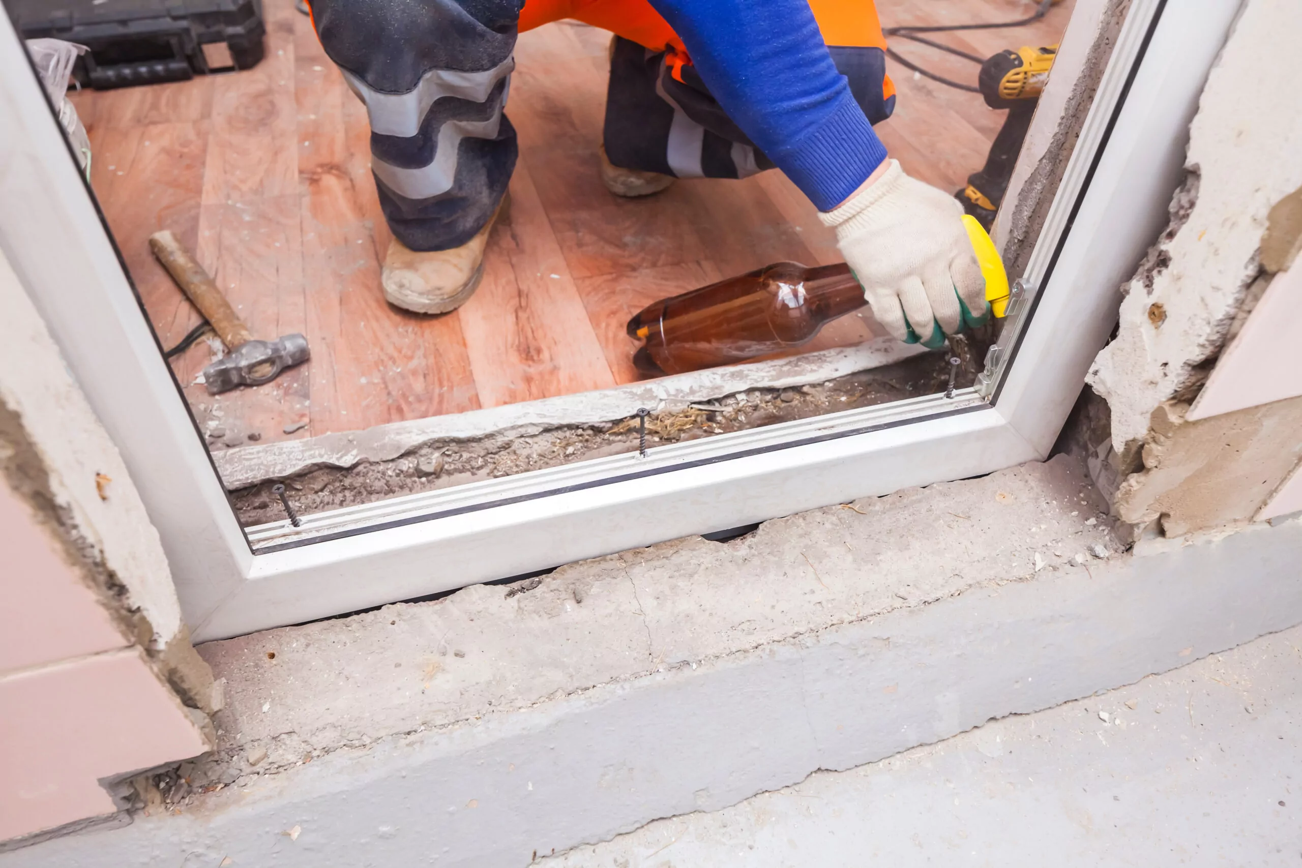 a man in safety gear is working on a window