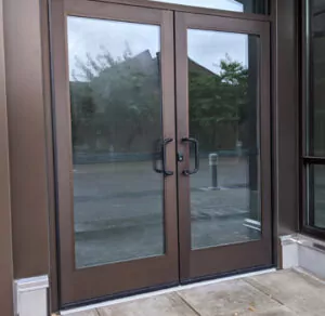 a brown double door with glass on the outside