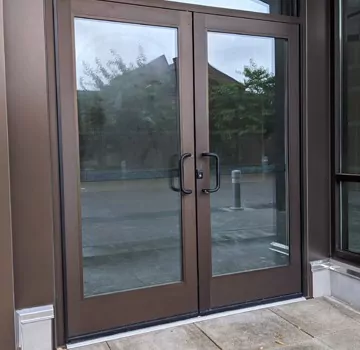 a brown double door with glass on the outside