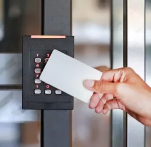 a hand holding a card in front of a door