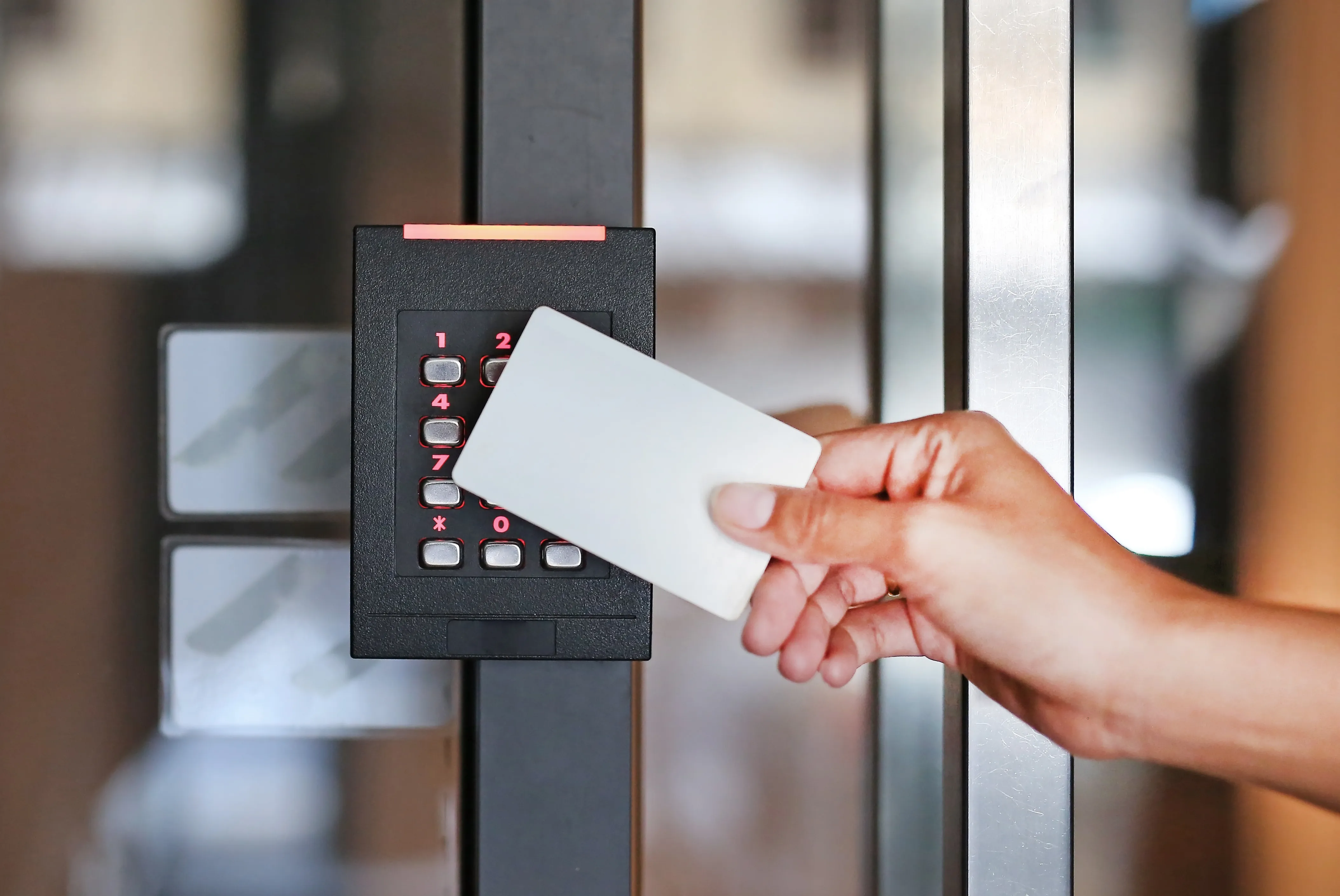 a hand is holding a card in front of a door